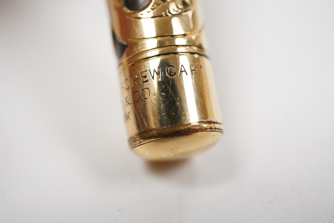 A Swan MT & Co. sterling silver filigree eyedropper along with similar gold filled example